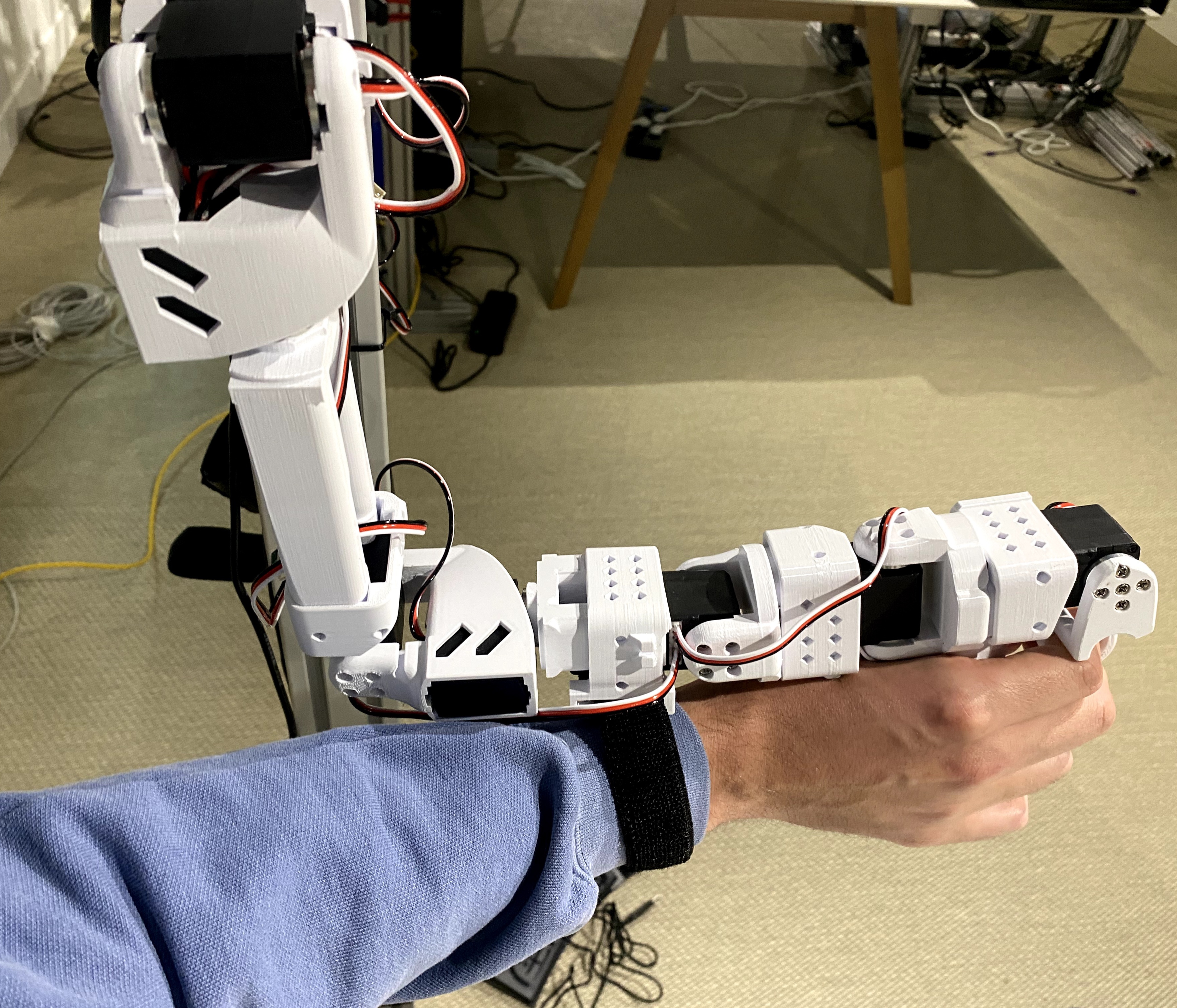 OpenArm Mini leader arm with wrist strap